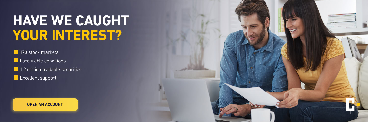 A smiling man and a smiling woman sit together at a laptop looking through papers; a banner ad lists financial services and offers an "open account" button.