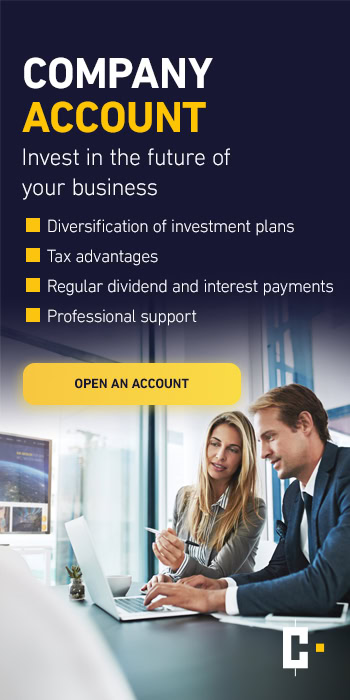 Two businessmen sit at a desk in a modern office, above them a text advertising corporate accounts and investment benefits.